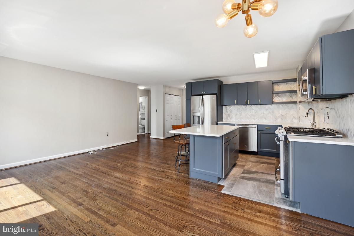 1200 South Arlington Ridge Road, Unit 618 Arlington, VA 22202 - Photo 17 of 17 a large kitchen with kitchen island a sink stainless steel appliances and cabinets