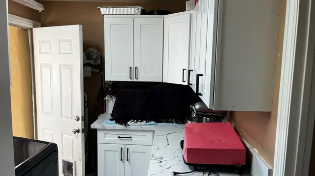 a kitchen with a refrigerator and a stove