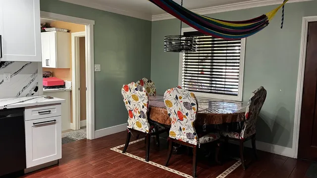 a dining room with furniture and wooden floor