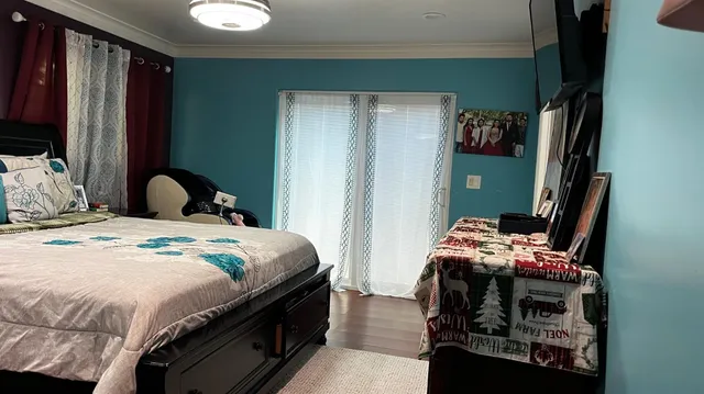 a bedroom with bed and a large window