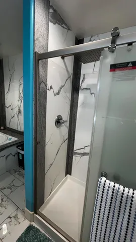 a bathroom with a granite countertop sink a toilet and a mirror