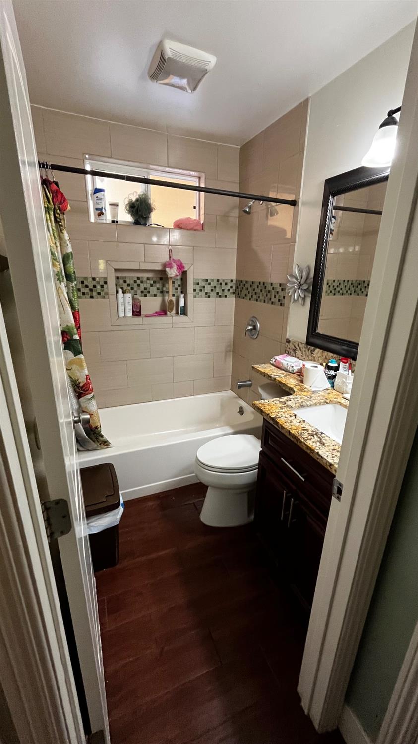 1738 U Street Rio Linda, CA 95673 - Photo 25 of 50 a bathroom with a sink a toilet a mirror and shower