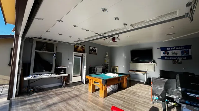 a room with gym equipment and a flat screen tv
