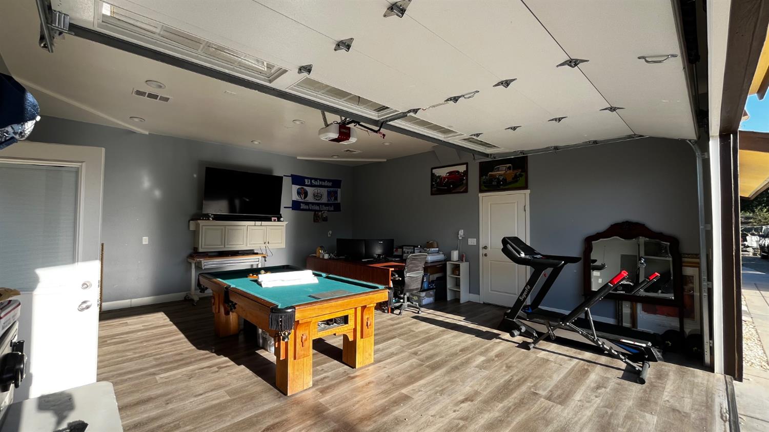 1738 U Street Rio Linda, CA 95673 - Photo 29 of 50 a room with gym equipment and a flat screen tv