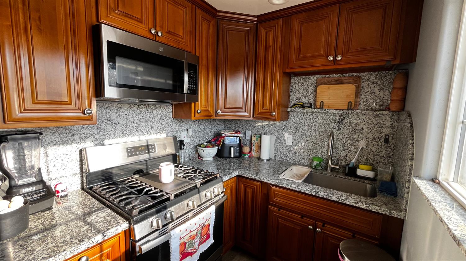 1738 U Street Rio Linda, CA 95673 - Photo 37 of 50 a kitchen with stainless steel appliances granite countertop a stove a microwave a sink and cabinets