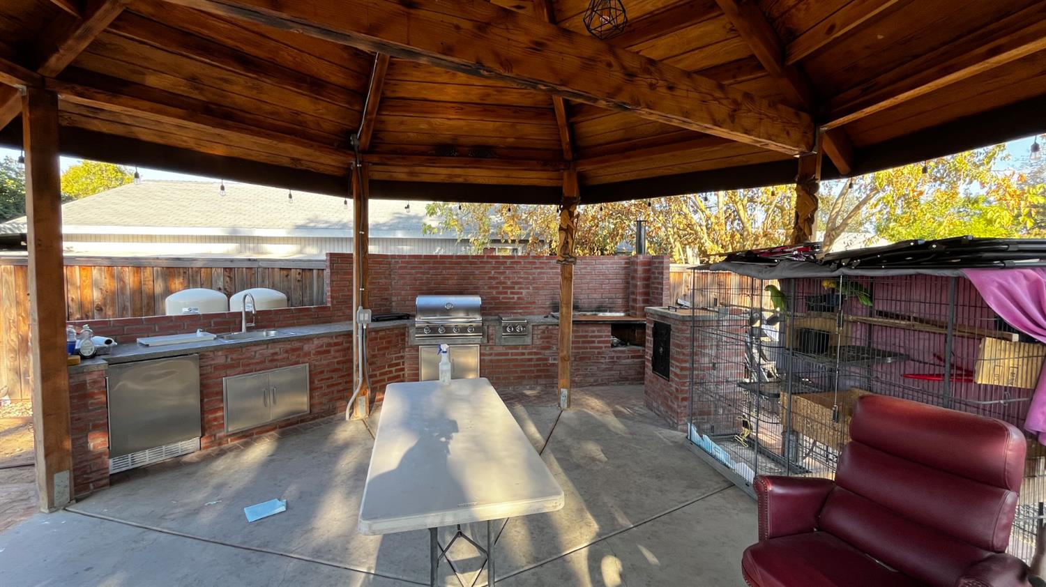 1738 U Street Rio Linda, CA 95673 - Photo 39 of 50 a view of a patio with table and chairs under an umbrella with a barbeque