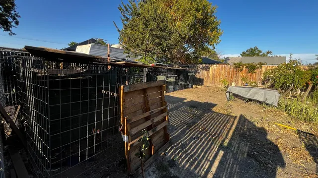 a view of a house with backyard space and sitting area