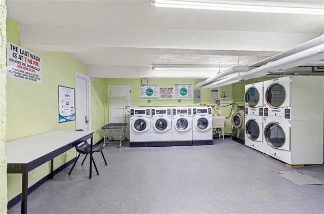 a utility room with stainless steel appliances granite countertop a stove and a car parked