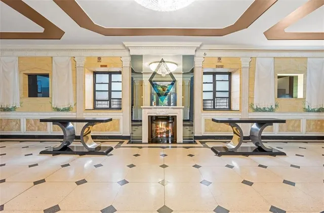 a view of a hall with a dining table and chairs