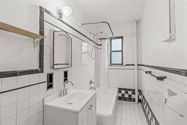 a bathroom with a sink a mirror and a bathtub