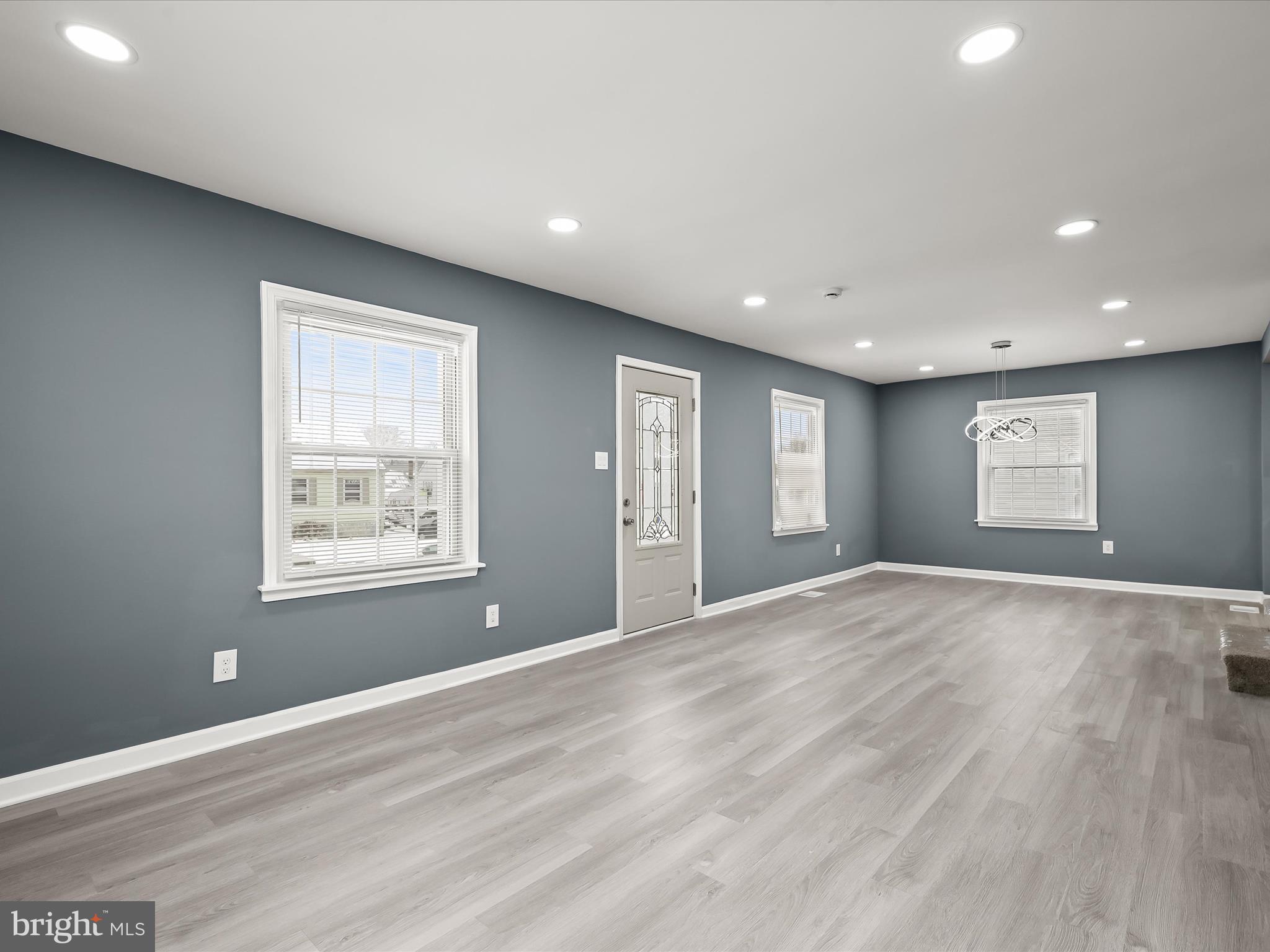 1709 Leslie Road Dundalk, MD 21222 - Photo 4 of 38 a view of an empty room with window and wooden floor