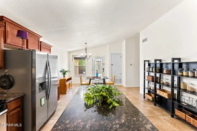 a living room with furniture a bookshelf and a refrigerator