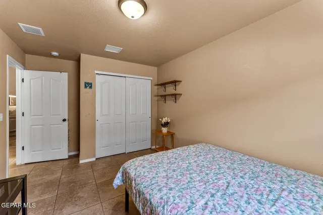 a bedroom with a bed and a shower