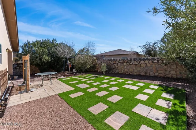 a view of a backyard with sitting area