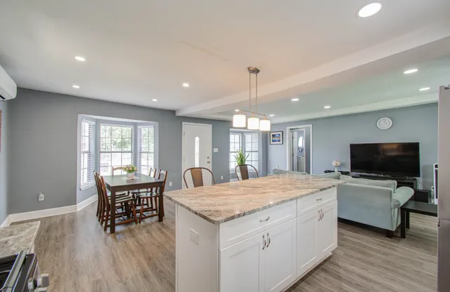 a living room with furniture and flat screen tv