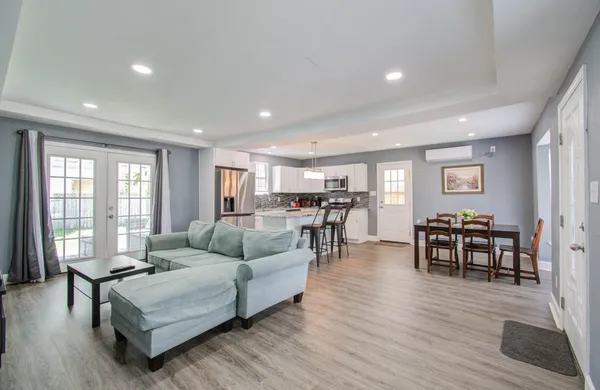 a living room with furniture and wooden floor