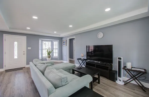 a living room with furniture and a flat screen tv