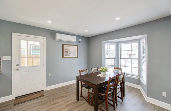 a view of a dining room with furniture and wooden floor