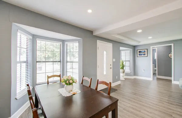 a view of a dining room with furniture window and wooden floor