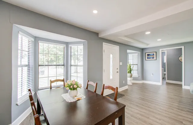 a view of a dining room with furniture window and wooden floor