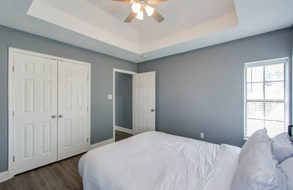 a bedroom with a bed and a chandelier
