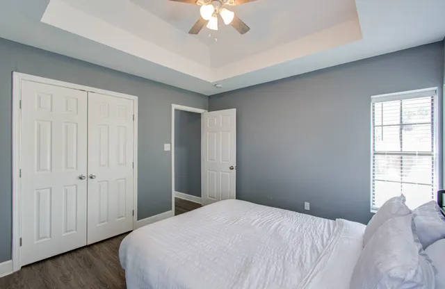 a bedroom with a bed and a chandelier