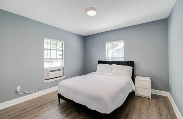 a bedroom with a bed and a window