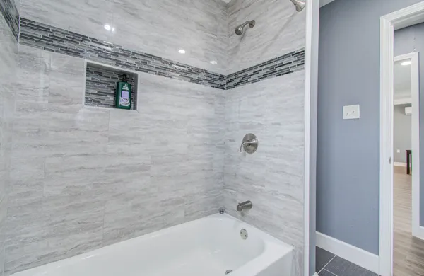 a bathroom with a bathtub and shower