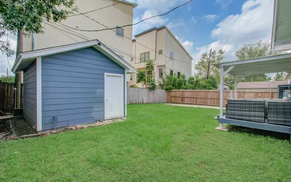 a view of a backyard with wooden fence