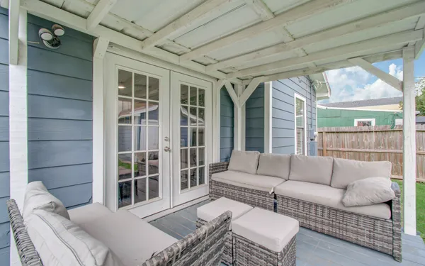 a balcony with furniture and a potted plant