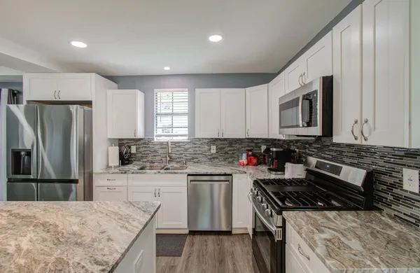 a kitchen with a stove a sink and a refrigerator