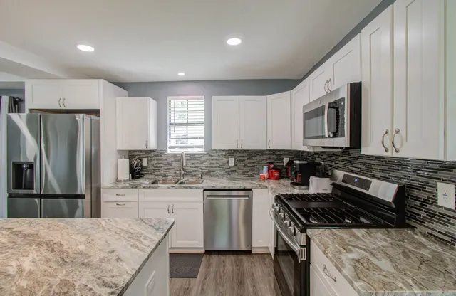 a kitchen with a stove a sink and a refrigerator