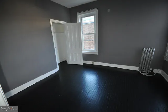 a view of wooden floor and windows in a room