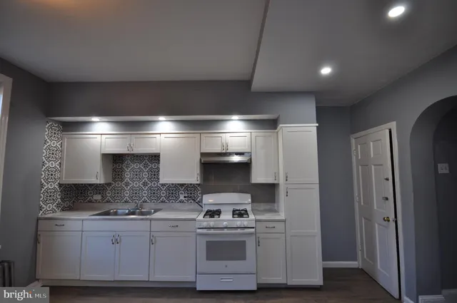 a kitchen with stainless steel appliances granite countertop a stove and a sink
