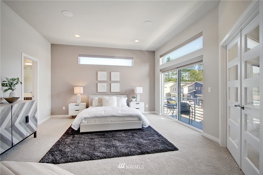 4423 232nd Place Southeast, Unit 19 Bothell, WA 98021 - Photo 15 of 23 a room with a large bed and wooden floor