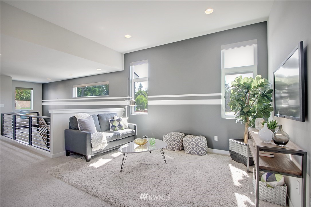 4423 232nd Place Southeast, Unit 19 Bothell, WA 98021 - Photo 19 of 23 a living room with furniture and a large window