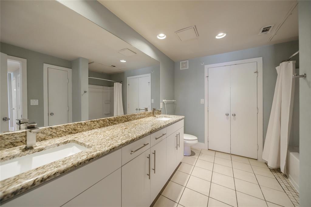 4414 Cedar Springs Road, Unit 214 Dallas, TX 75219 - Photo 18 of 29 Bathroom with light tile patterned floors, double vanity, recessed lighting, shower / bath combo, and a closet