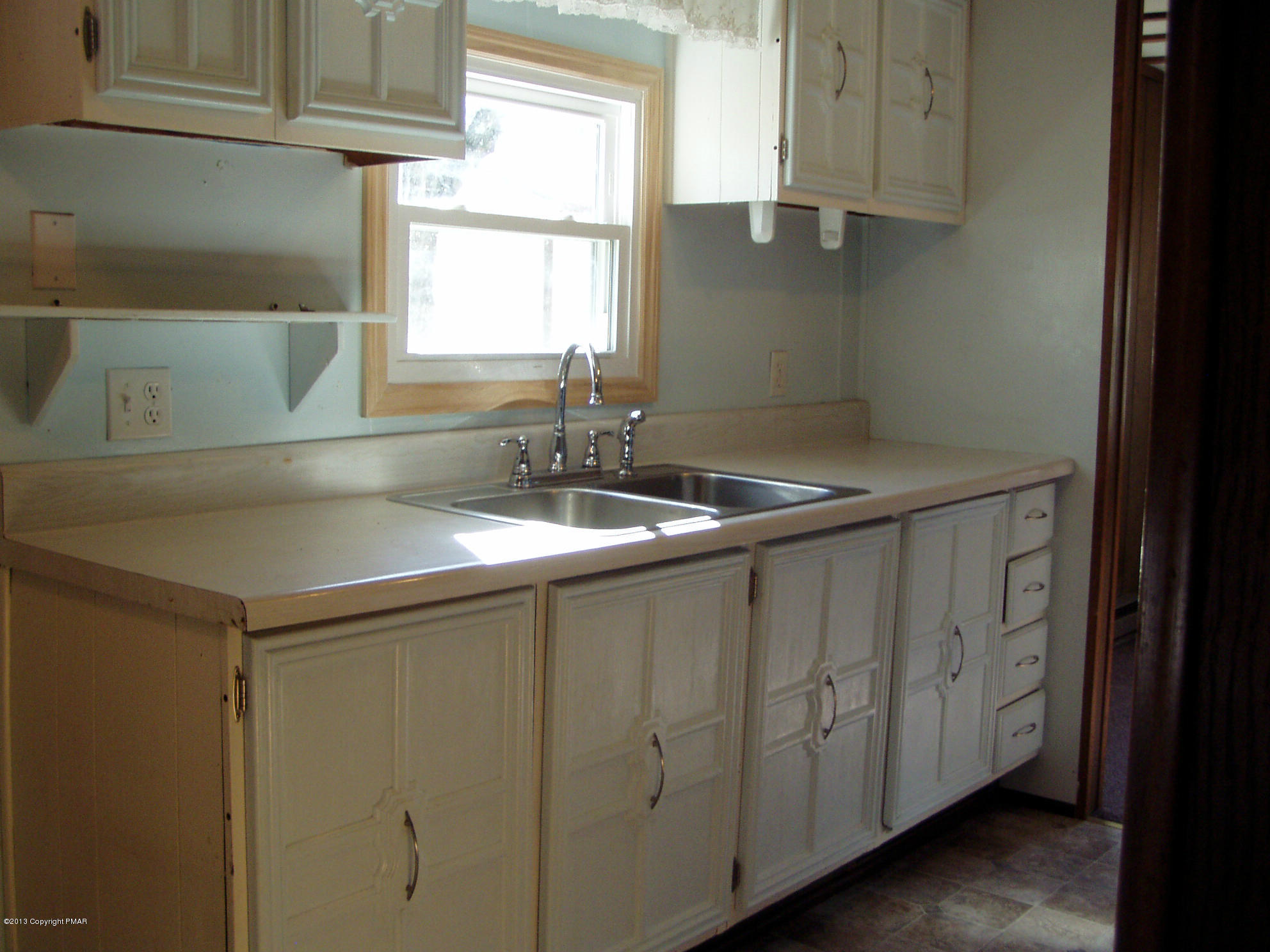 340 Summit Road Swiftwater, PA 18370 - Photo 8 of 16 a kitchen with a sink and cabinets