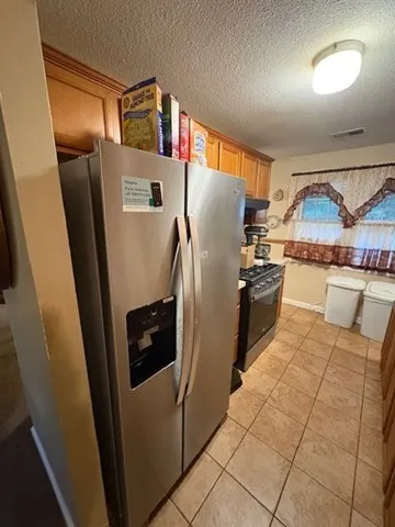 a kitchen with stainless steel appliances a refrigerator and a stove