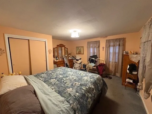 a bed room with a bed and a view of bedroom