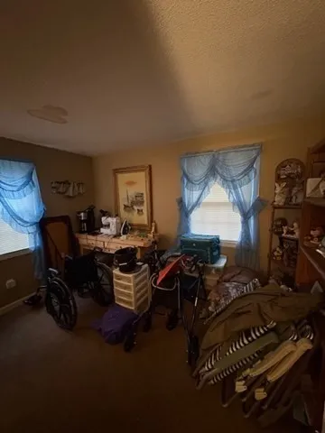 a living room with furniture a air conditioner vent and a window