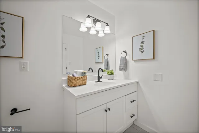 a bathroom with a sink a mirror and a vanity