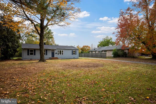 a front view of house with yard and trees