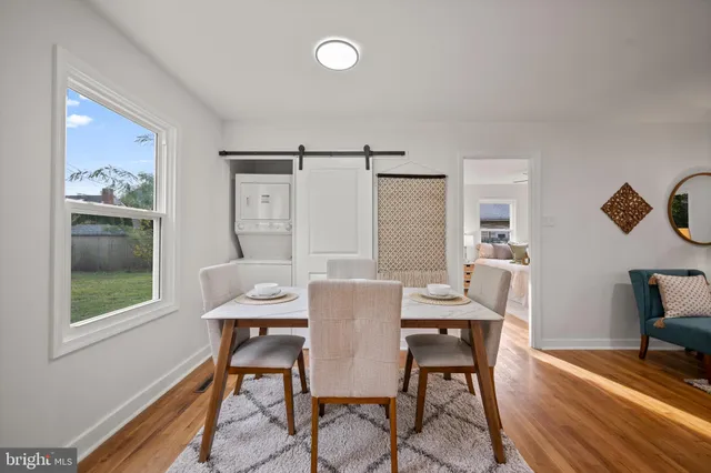 a view of a dining room with furniture window and wooden floor