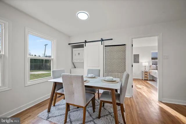 a view of a dining room with furniture and wooden floor