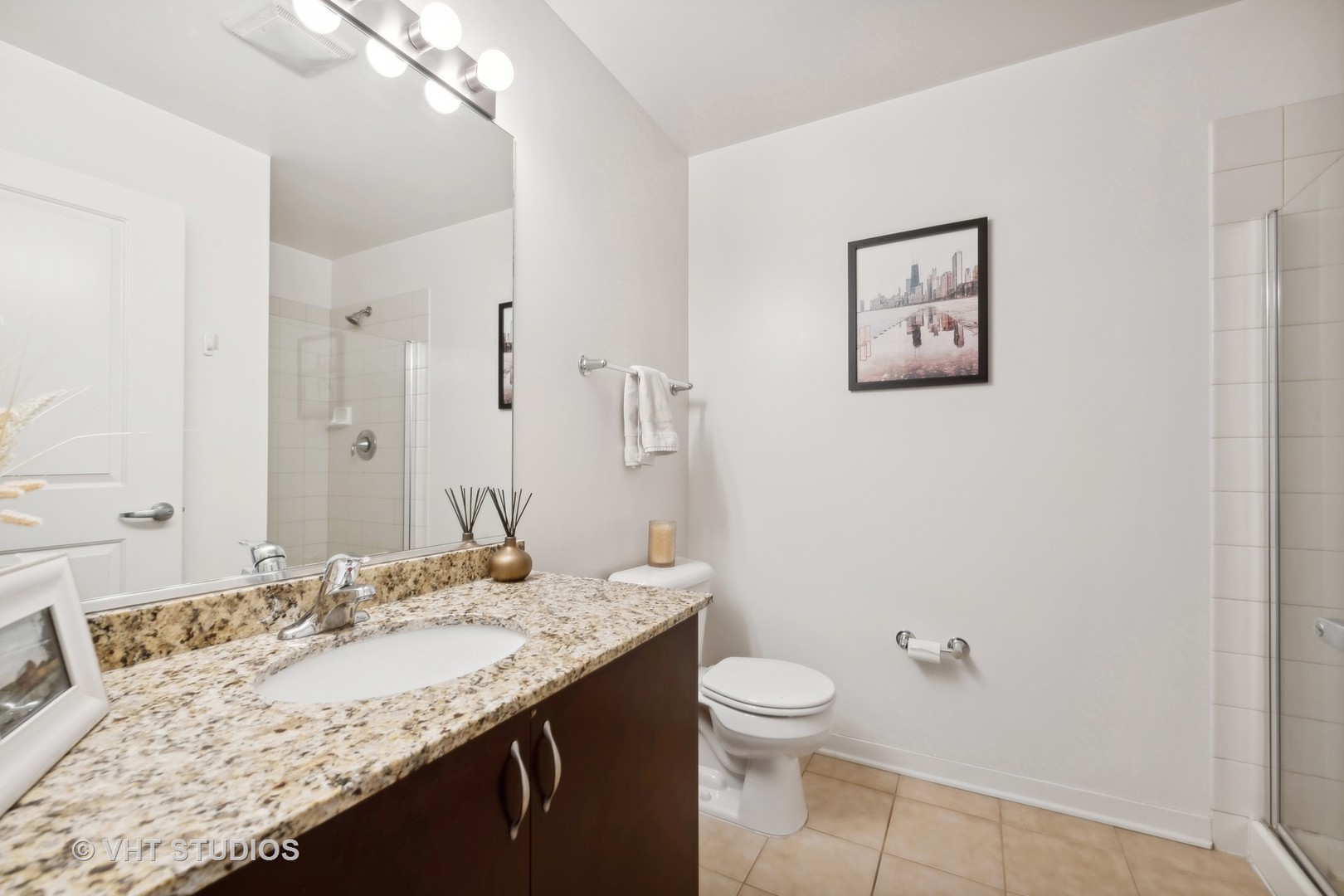 437 West Division Street, Unit 618 Chicago, IL 60610 - Photo 11 of 17 a bathroom with a granite countertop sink a toilet and a shower