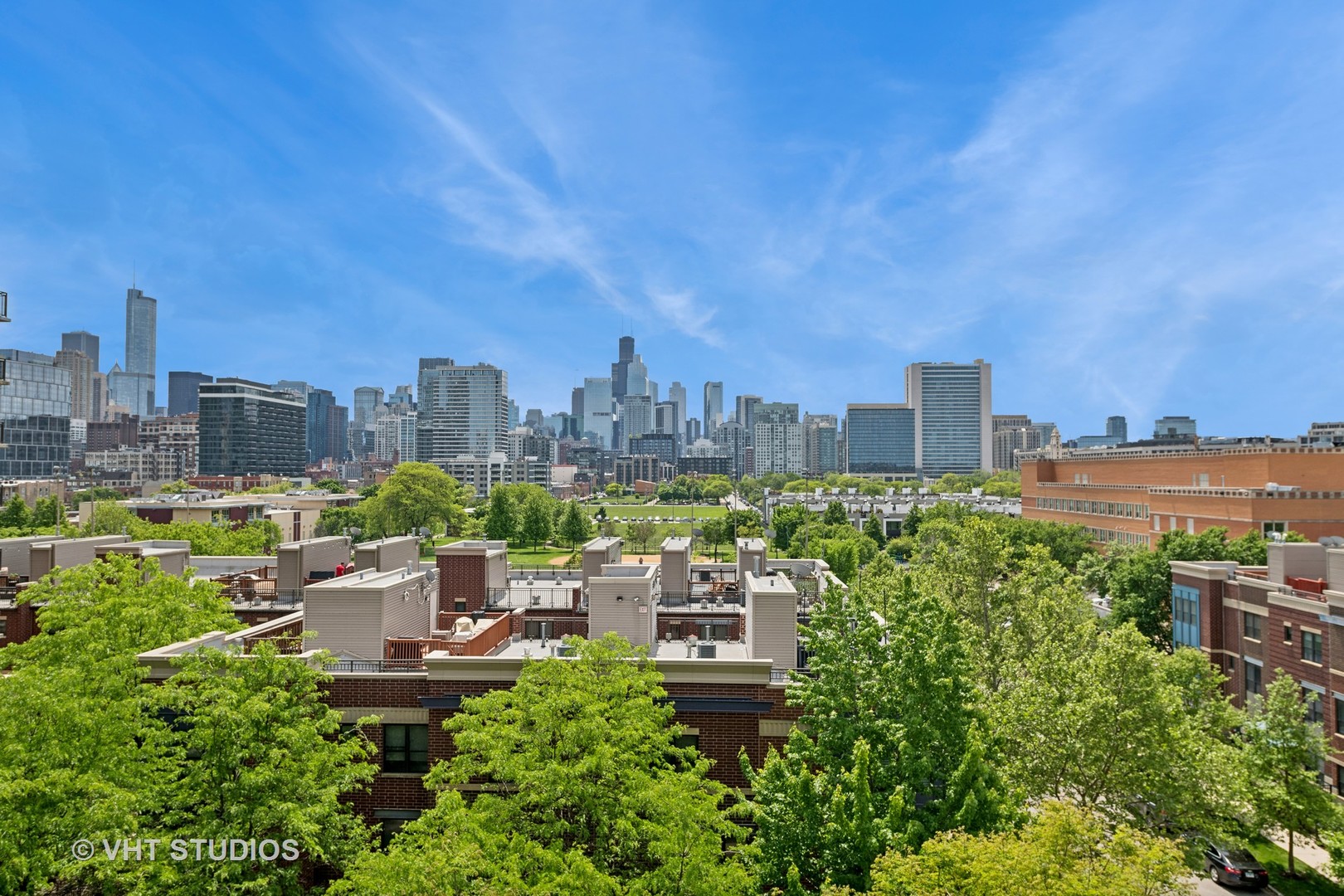 437 West Division Street, Unit 618 Chicago, IL 60610 - Photo 16 of 17 a view of a city with lawn chairs and a fire pit