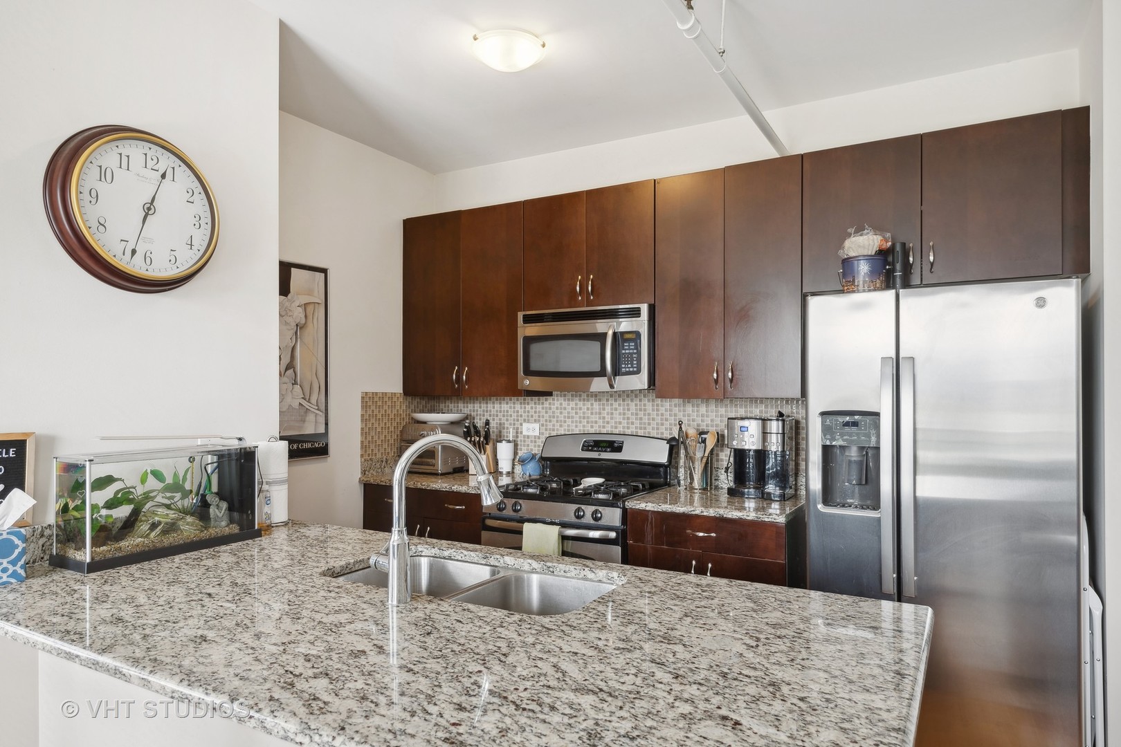 437 West Division Street, Unit 618 Chicago, IL 60610 - Photo 6 of 17 a kitchen with a refrigerator a stove a sink and a dining table