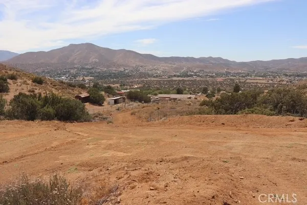 a view of a large mountain with mountains in the background