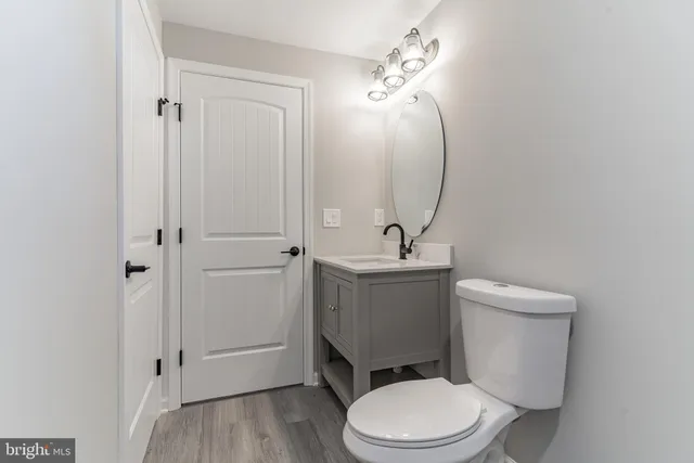 a white toilet sitting next to a bathroom sink